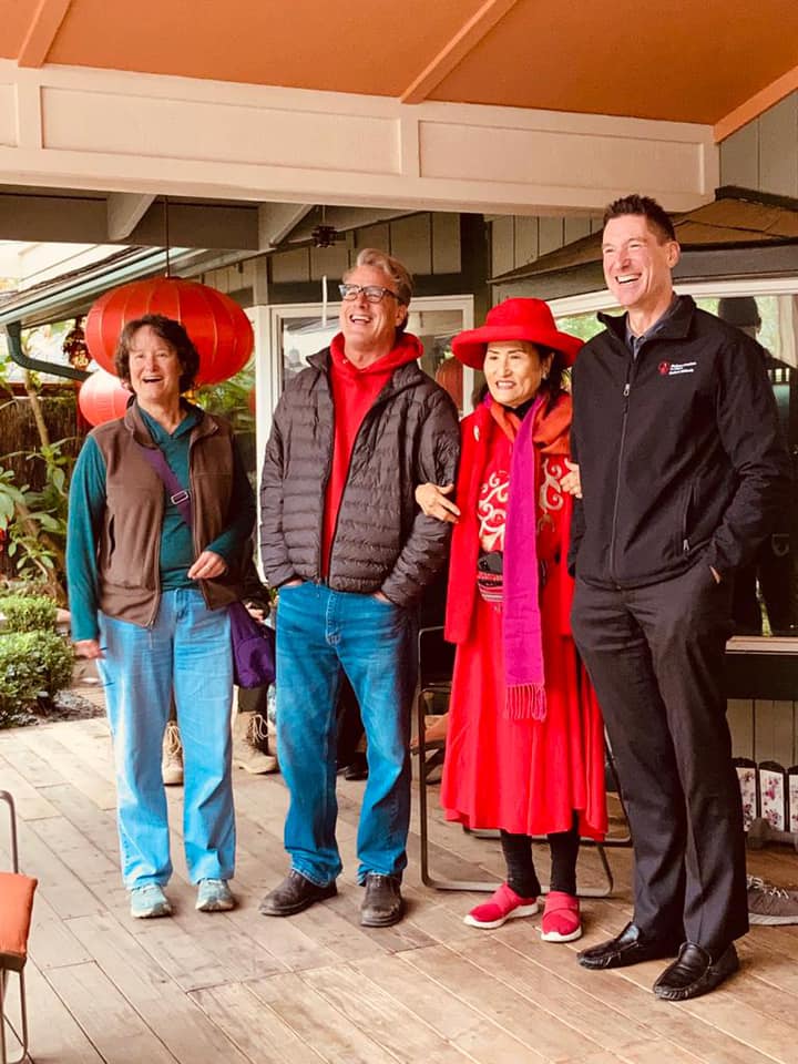 Guests enjoying the porch with lanterns during a Shriners event
