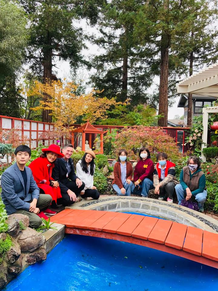 Group photo by the blue pond and bridge